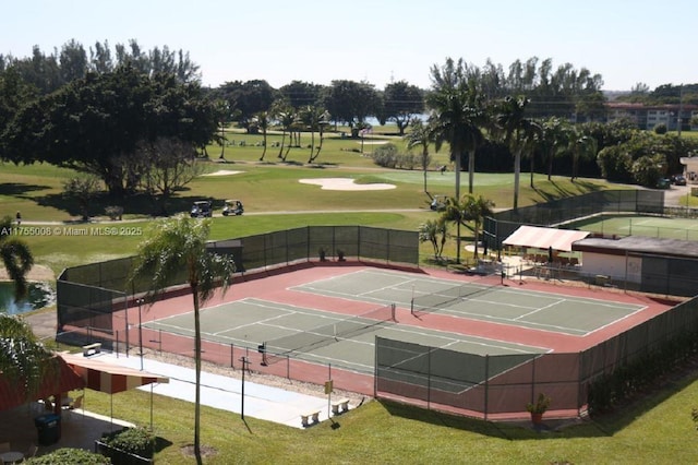 view of sport court featuring view of golf course, a lawn, and fence