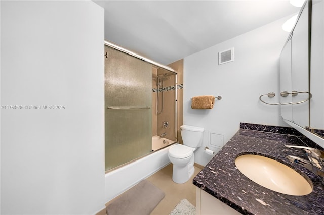 bathroom with tile patterned flooring, toilet, vanity, visible vents, and combined bath / shower with glass door