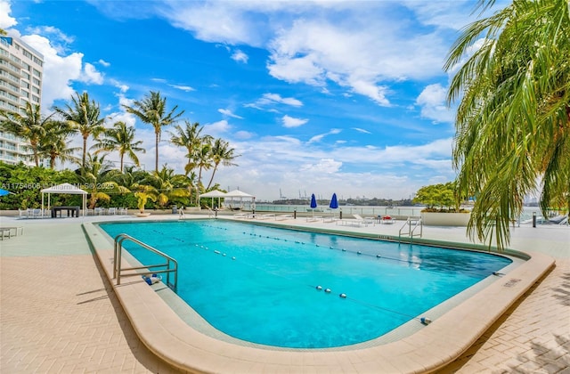 community pool with a patio area and a gazebo