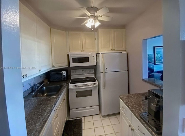 kitchen featuring light tile patterned floors, ceiling fan, white appliances, a sink, and white cabinetry