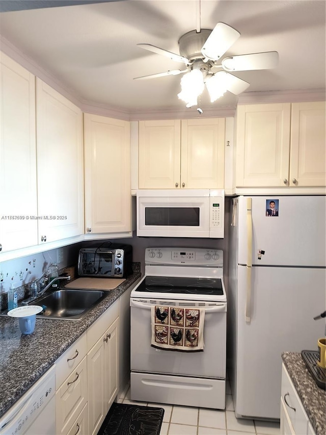 kitchen featuring white appliances, a toaster, ceiling fan, white cabinetry, and a sink