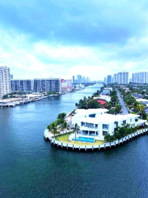 drone / aerial view featuring a view of city and a water view