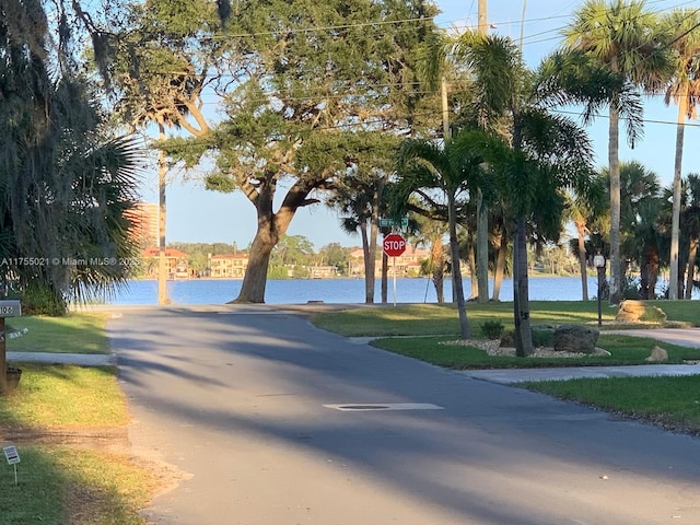 view of road featuring traffic signs and a water view