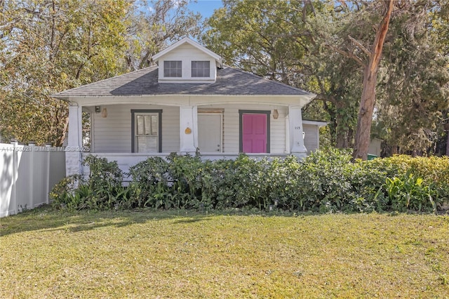 bungalow-style home featuring a front yard and fence