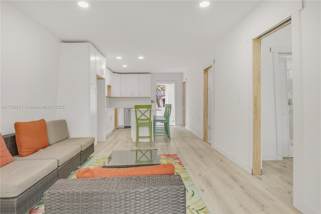 living room with light wood-style flooring and recessed lighting