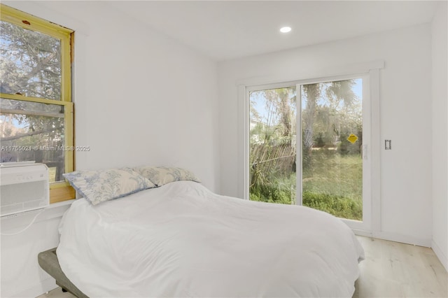 bedroom with access to exterior, cooling unit, wood finished floors, and recessed lighting