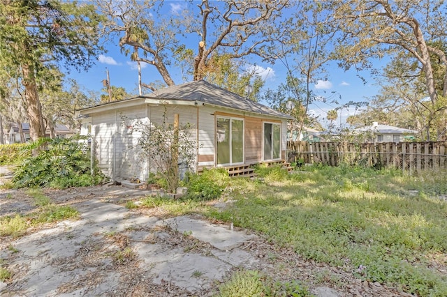 exterior space with an outbuilding and fence