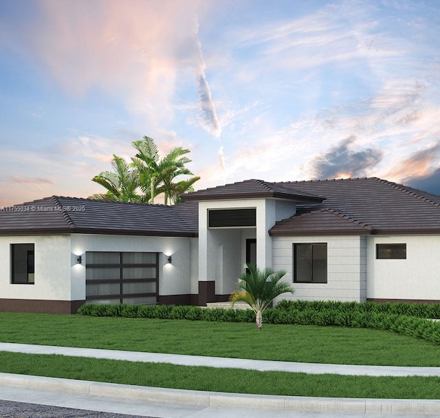 view of front facade with a tile roof, a front lawn, and stucco siding