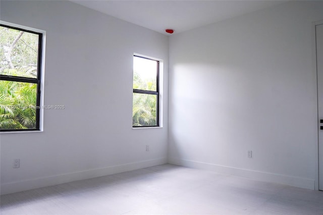 spare room with baseboards