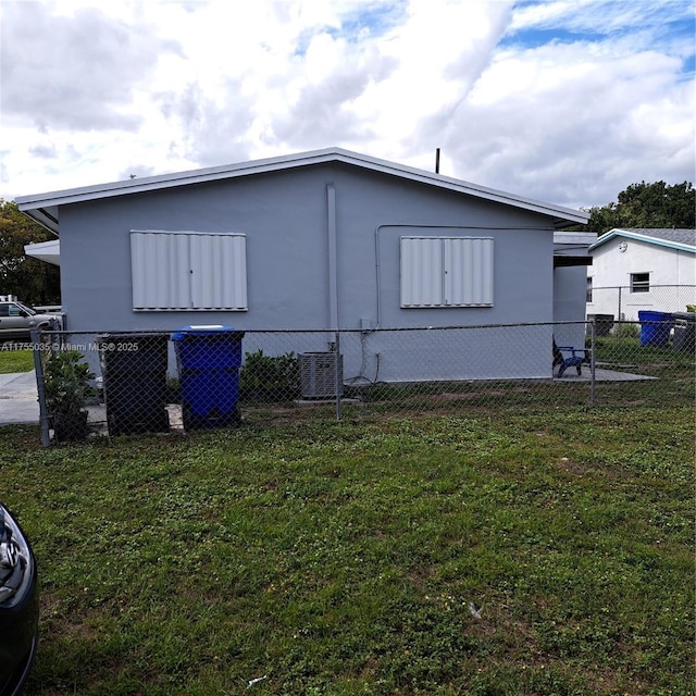 exterior space with fence and central AC unit