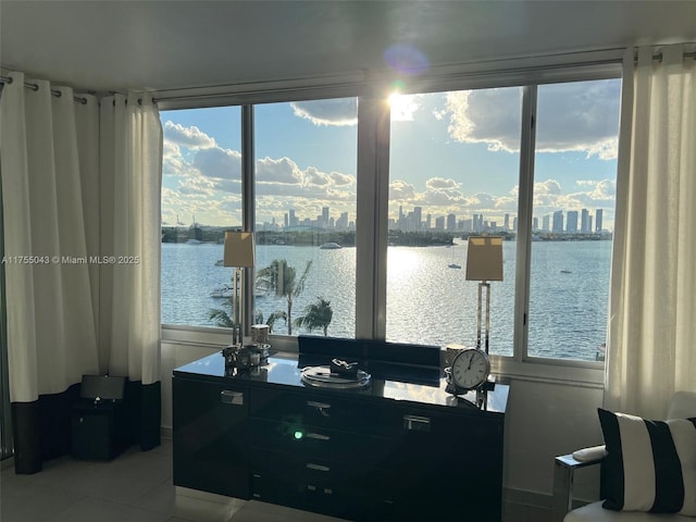 office area with a water view, a city view, and light tile patterned floors