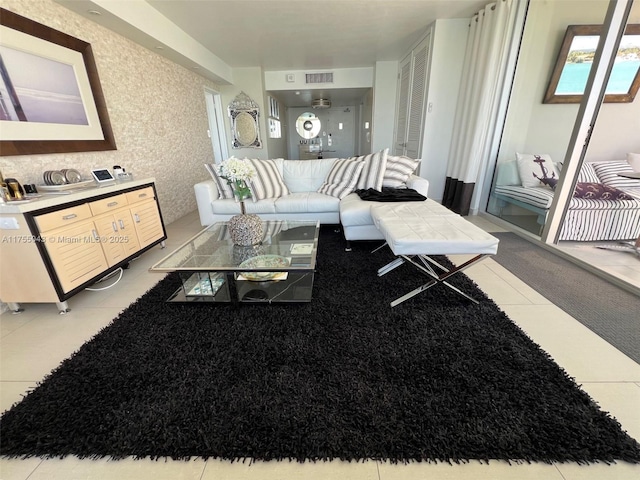 living area featuring tile patterned flooring and visible vents