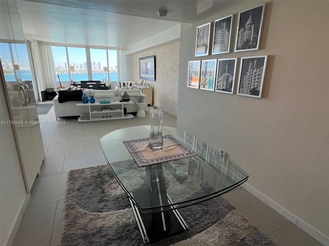 tiled dining area with a view of city and baseboards