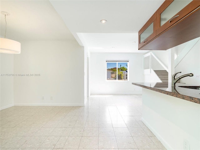 interior space featuring baseboards, stairway, light tile patterned flooring, a sink, and recessed lighting