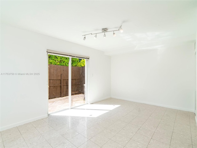 1323 NE 5th Ave, Fort Lauderdale, FL 33304 - spare room with baseboards and rail lighting