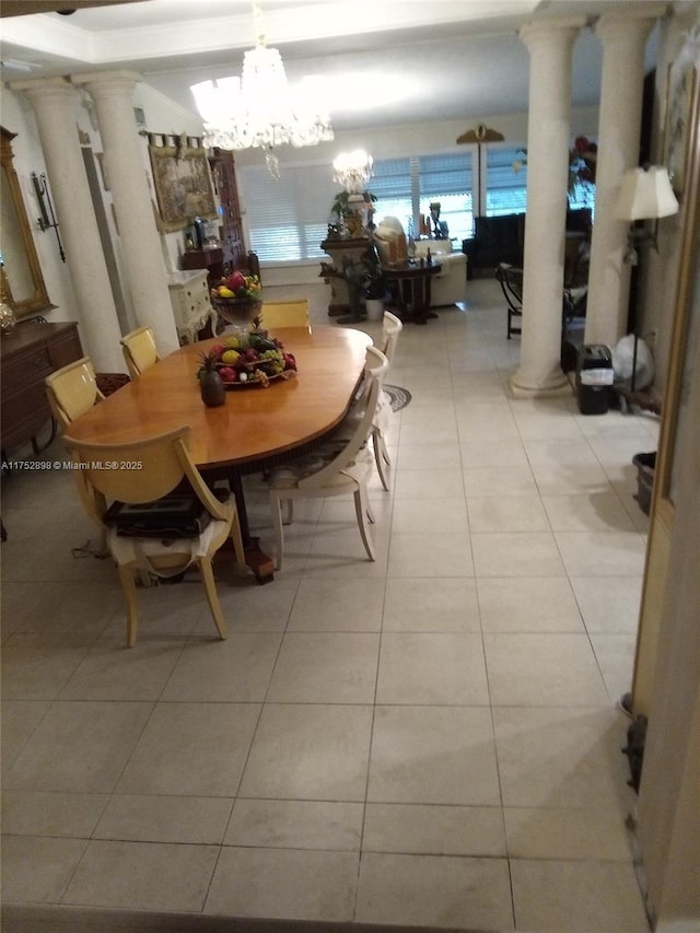 dining room featuring light tile patterned floors, decorative columns, and a notable chandelier