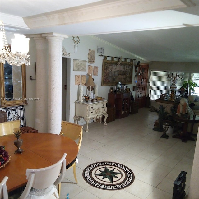 dining space with lofted ceiling, ornamental molding, ornate columns, a notable chandelier, and light tile patterned flooring