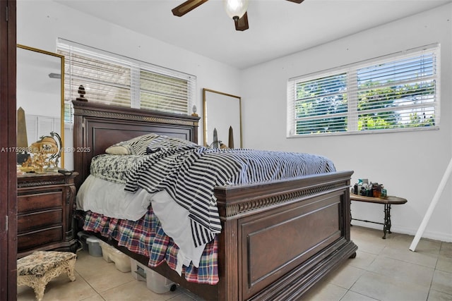 bedroom featuring light tile patterned floors, ceiling fan, and baseboards