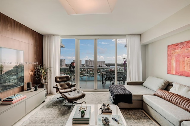 living area with a wall of windows and a city view