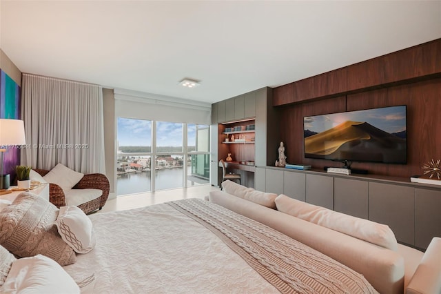 bedroom featuring access to outside and wooden walls