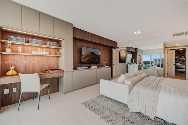 living room with visible vents and wooden walls