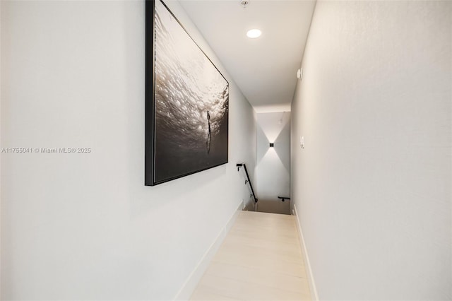 corridor with recessed lighting, an upstairs landing, and baseboards