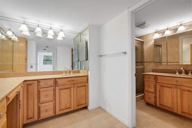 full bath featuring visible vents, baseboards, tile patterned floors, vanity, and a shower stall