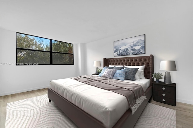 bedroom featuring light wood-style floors and baseboards