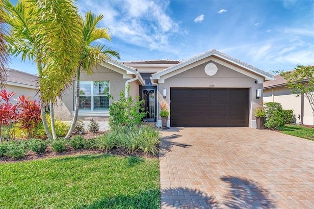 ranch-style home with decorative driveway, an attached garage, and stucco siding