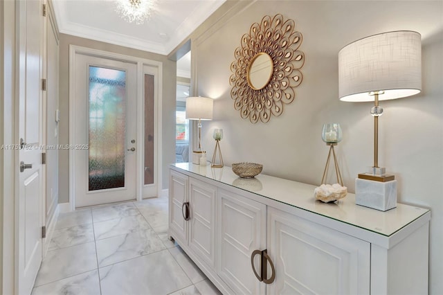 foyer entrance featuring marble finish floor and ornamental molding