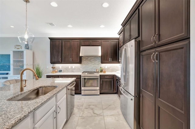 kitchen featuring tasteful backsplash, marble finish floor, stainless steel appliances, under cabinet range hood, and a sink