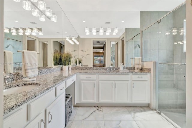 full bath with marble finish floor, visible vents, a shower stall, and vanity