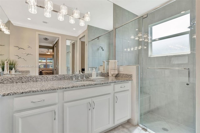 full bathroom featuring a stall shower, plenty of natural light, vanity, and crown molding