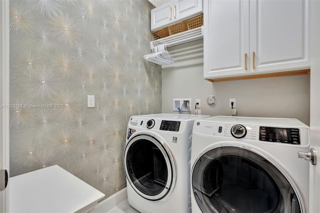 laundry area featuring washer and clothes dryer and cabinet space