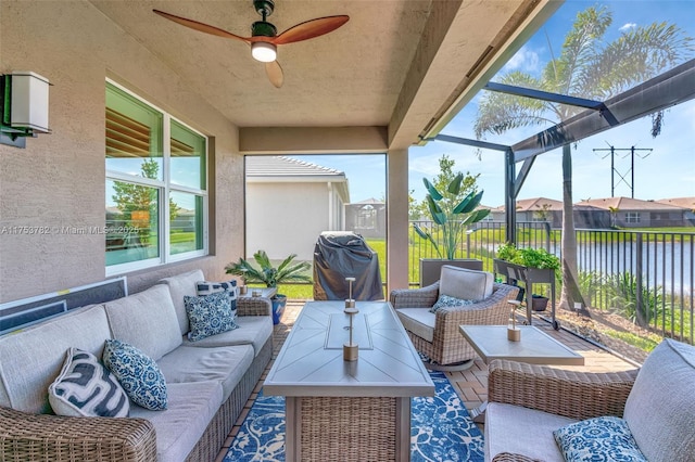 view of patio with a lanai, an outdoor hangout area, fence, a grill, and a ceiling fan
