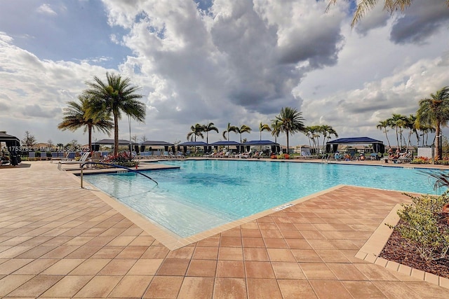 pool with a patio and a gazebo