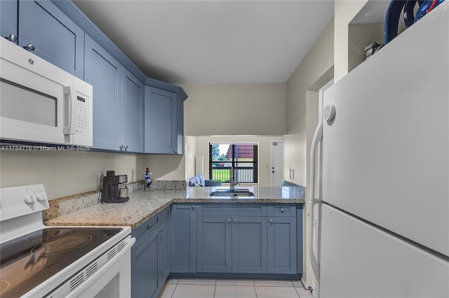 kitchen featuring white appliances, a sink, blue cabinetry, and light tile patterned floors