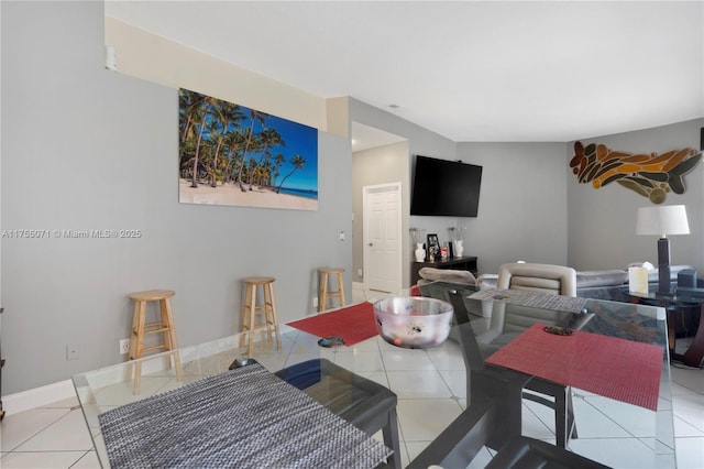 dining space with baseboards and tile patterned floors