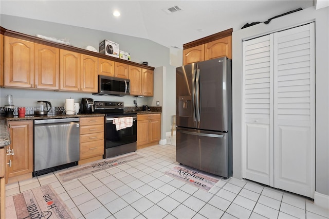 kitchen with light tile patterned floors, stainless steel appliances, visible vents, vaulted ceiling, and dark stone counters