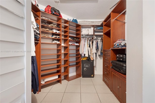 spacious closet featuring light tile patterned floors