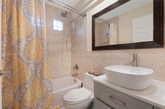 bathroom with shower / tub combo with curtain, tile walls, toilet, and vanity