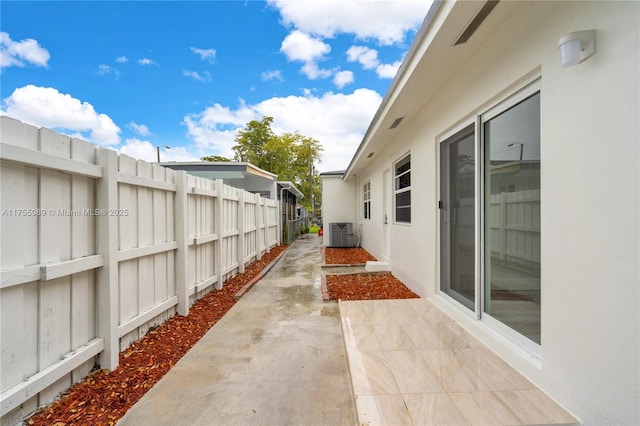 view of patio / terrace with central AC and fence