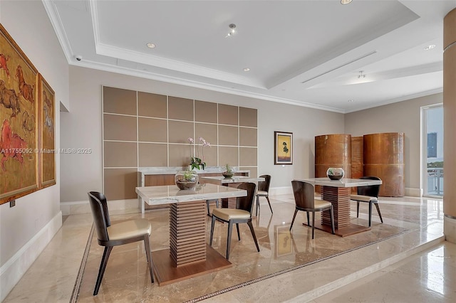 dining space with a tray ceiling and marble finish floor