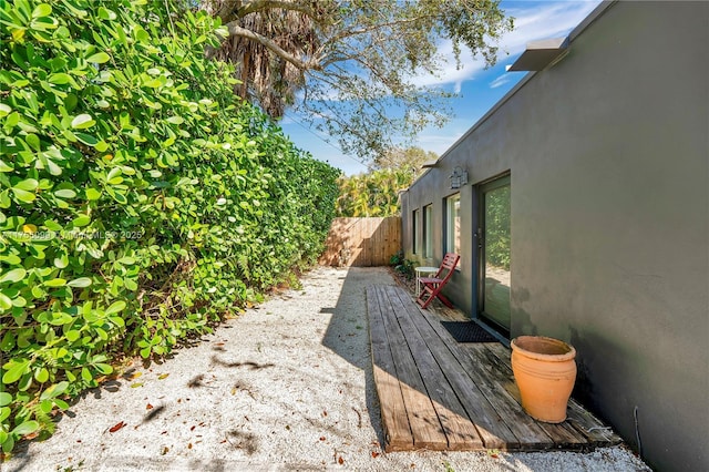 view of yard featuring a deck and fence