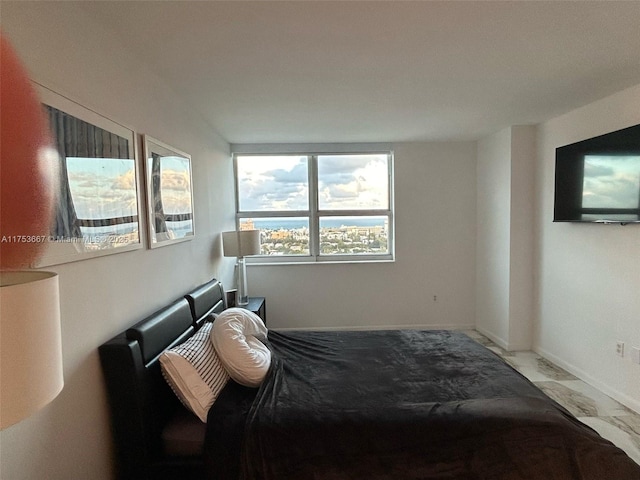 bedroom with marble finish floor and baseboards