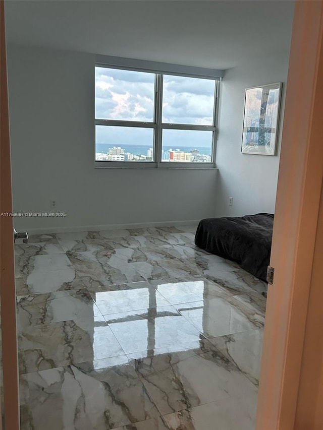 unfurnished bedroom featuring marble finish floor