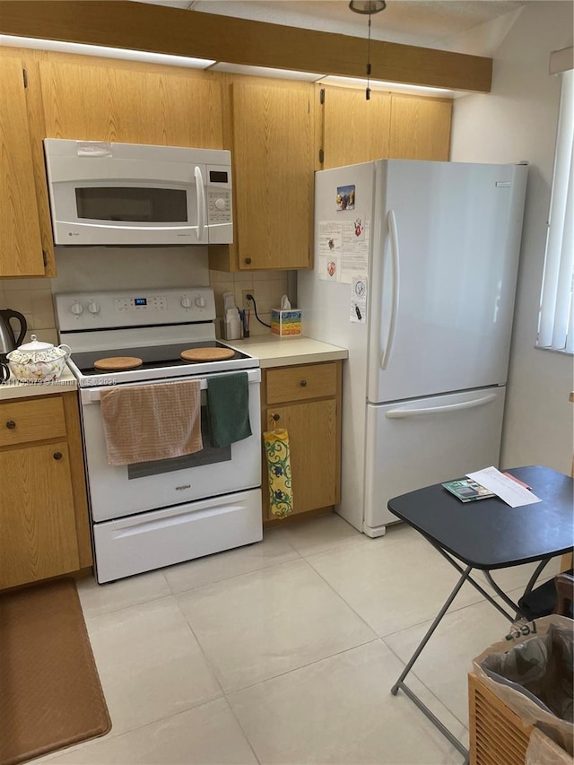 kitchen with white appliances, tasteful backsplash, and light countertops