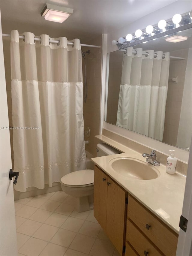 bathroom with vanity, shower / tub combo, tile patterned flooring, and toilet