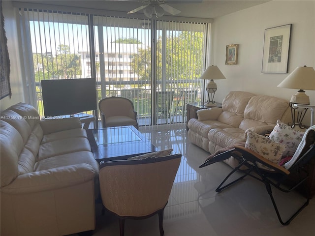 tiled living room with a healthy amount of sunlight and ceiling fan