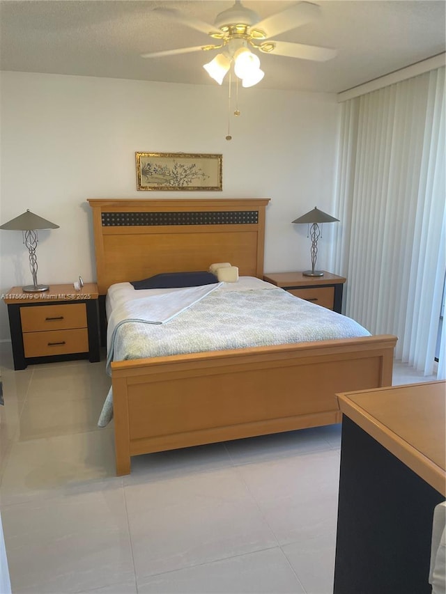 bedroom featuring light tile patterned floors and a ceiling fan